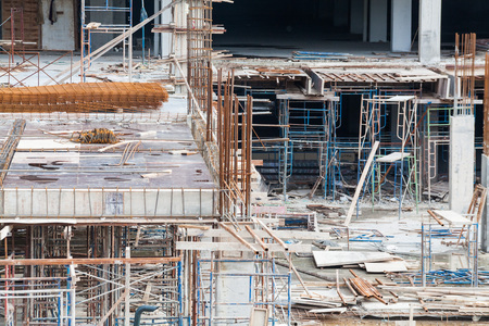 Construction site view of crane, lift, metal beam, brick, metal ladder and concreteの写真素材