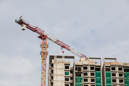 Construction site view of crane, lift, metal beam, brick, metal ladder and concreteの写真素材