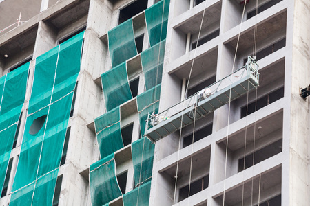 Construction site view of crane, lift, metal beam, brick, metal ladder and concreteの写真素材