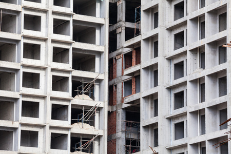Construction site view of crane, lift, metal beam, brick, metal ladder and concreteの写真素材