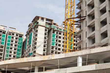 Construction site view of crane, lift, metal beam, brick, metal ladder and concreteの写真素材