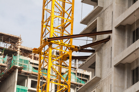 Construction site view of crane, lift, metal beam, brick, metal ladder and concreteの写真素材