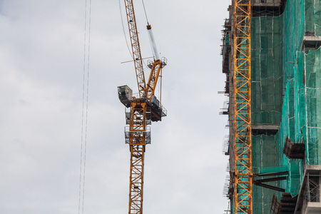 Construction site view of crane, lift, metal beam, brick, metal ladder and concreteの写真素材
