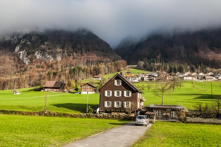 Holiday in Switzerland - Beautiful foggy view of winter landscape towards Engelberg, Switzerlandのeditorial素材