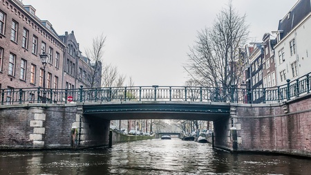 Amsterdam Holland, 4 December 2014 : Canal Cruises view of Amsterdam. Amsterdam is the Netherlandsâ capital, known for its artistic heritage, elaborate canal system and narrow houses with gabled facades, legacies of the cityâs 17th-century Golden Age.のeditorial素材