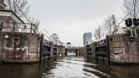 Amsterdam Holland, 4 December 2014 : Canal Cruises view of Amsterdam. Amsterdam is the Netherlandsâ capital, known for its artistic heritage, elaborate canal system and narrow houses with gabled facades, legacies of the cityâs 17th-century Golden Age.のeditorial素材