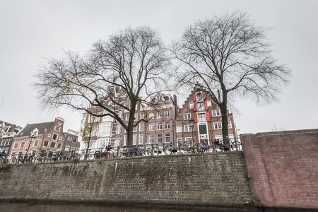 Amsterdam Holland, 4 December 2014 : Canal Cruises view of Amsterdam. Amsterdam is the Netherlandsâ capital, known for its artistic heritage, elaborate canal system and narrow houses with gabled facades, legacies of the cityâs 17th-century Golden Age.のeditorial素材