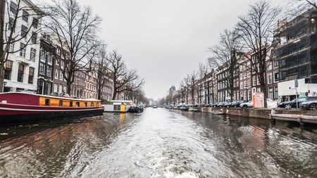 Amsterdam Holland, 4 December 2014 : Canal Cruises view of Amsterdam. Amsterdam is the Netherlandsâ capital, known for its artistic heritage, elaborate canal system and narrow houses with gabled facades, legacies of the cityâs 17th-century Golden Age.のeditorial素材