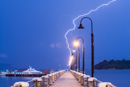 Lightning bolt strike into sea with natural lens flareのeditorial素材