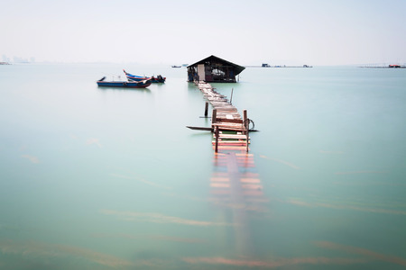 Water overflow on a broken wooden bridgeの写真素材