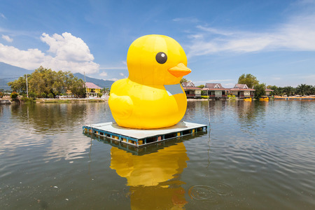 Huge yellow balloon duck on top of lake or seaの写真素材