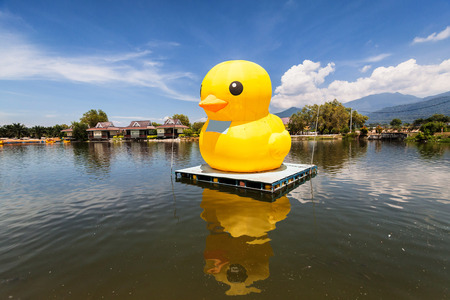 Huge yellow balloon duck on top of lake or seaの写真素材