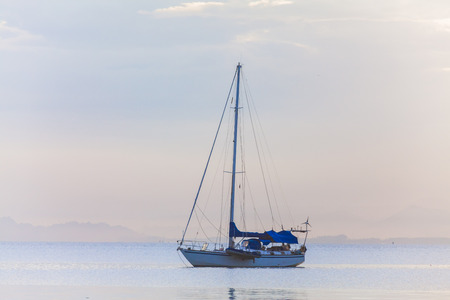 Lonely boat in a calm sea for backgroundの写真素材
