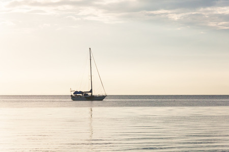 Lonely boat in a calm sea for backgroundの写真素材