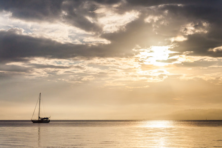 Lonely boat in a calm sea for backgroundの写真素材