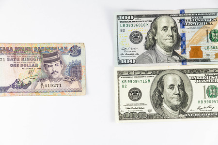 Close up view of US Dollar and Brunei Dollar indicating strong currency exchange rateの写真素材