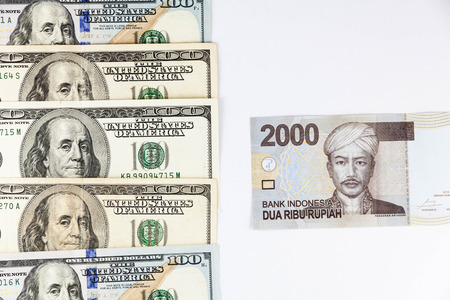 Close up view of US Dollar and Indonesia Rupiah indicating strong currency exchange rateの写真素材