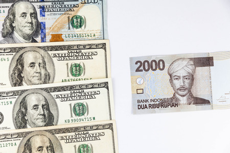Close up view of US Dollar and Indonesia Rupiah indicating strong currency exchange rateの写真素材