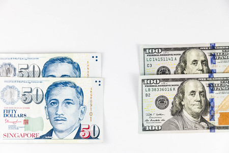 Close up view of US Dollar and Singapore Dollar indicating strong currency exchange rateの写真素材