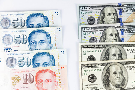 Close up view of US Dollar and Singapore Dollar indicating strong currency exchange rateの写真素材
