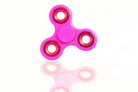 Fidget Spinner in white isolated background for stress release during workの写真素材
