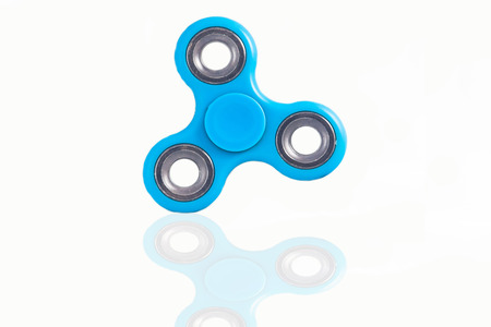 Fidget Spinner in white isolated background for stress release during workの写真素材