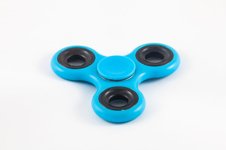 Fidget Spinner in white isolated background for stress release during workの写真素材