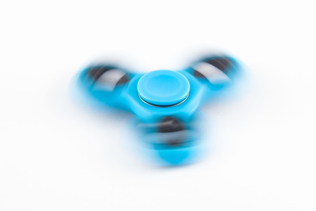 Fidget Spinner in white isolated background for stress release during workの写真素材