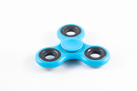 Fidget Spinner in white isolated background for stress release during workの写真素材