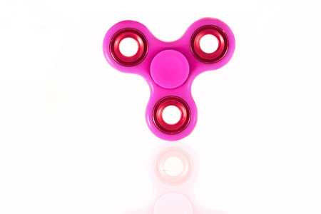 Fidget Spinner in white isolated background for stress release during workの写真素材