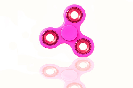 Fidget Spinner in white isolated background for stress release during workの写真素材