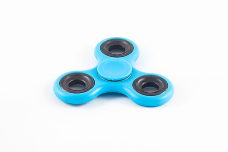 Fidget Spinner in white isolated background for stress release during workの写真素材