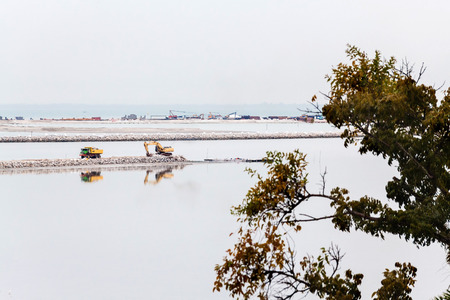 Land reclamation lorry carry sands and rocks on the shoreの写真素材