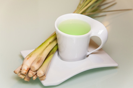 Lemon grass drink with a white cup view in close up with blur isolated backgroundの写真素材