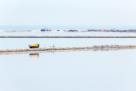 Land reclamation lorry carry sands and rocks on the shoreの写真素材