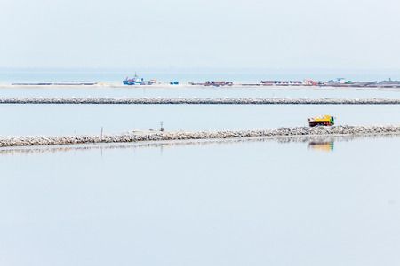 Land reclamation lorry carry sands and rocks on the shoreの写真素材