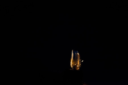 Close up view of real sparking light from lighter in dark black backgroundの写真素材