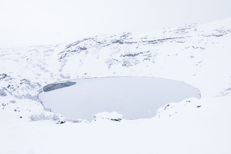Kerid volcano crater during winter snow in Icelandの写真素材