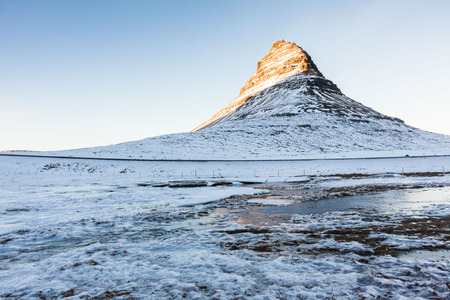 Kirkjufell view during winter snow which is a high mountain on the north coast of Iceland's Snaefellsnes peninsula, near the town of Grundarfjordurの写真素材