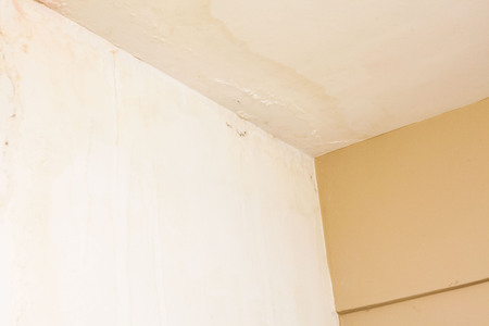 Dirt watery ceiling leaking view indicating dangerous of flood and mold growの写真素材