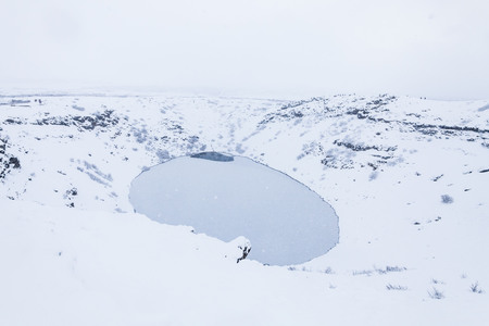 Kerid volcano crater during winter snow in Icelandの写真素材