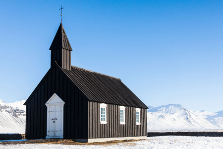 Budakirkja or better known as The Black Church view with blue sky during winter snow, Icelandの写真素材