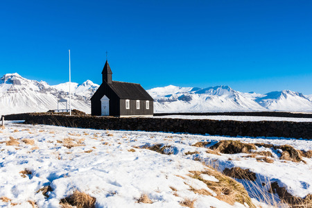 Budakirkja or better known as The Black Church view with blue sky during winter snow, Icelandの写真素材