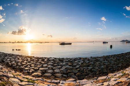 Sunrise or sunset landscape view by the shore for beautiful backgroundの写真素材