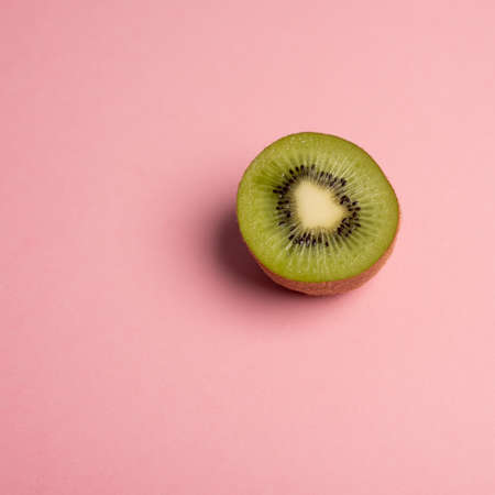 Kiwi half on pink background desk square crop postの写真素材