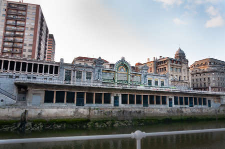 Bilbao, Euskal Herria, Spain - 09 04 2018: Bilbao La Naja old train station, Nervion river and residential buildings with nice blue sky copy space. This station stopped its activity in 1999のeditorial素材