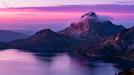 Mountain peak at sunset with lake reflectionの素材