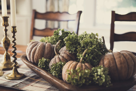 Autumn table setting with pumpkins and fresh herbs in rustic style