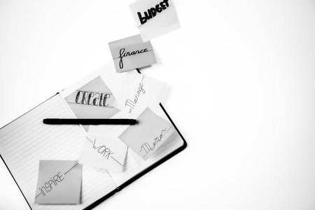 Notebook and pen on white background with copy space for text.