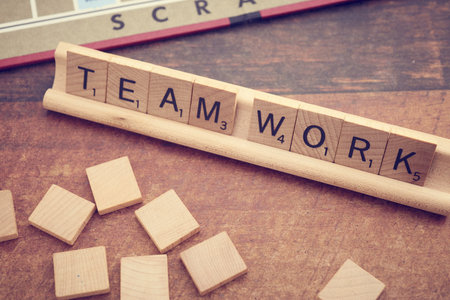 Teamwork word on wood block on wooden table background. Business concept.の写真素材